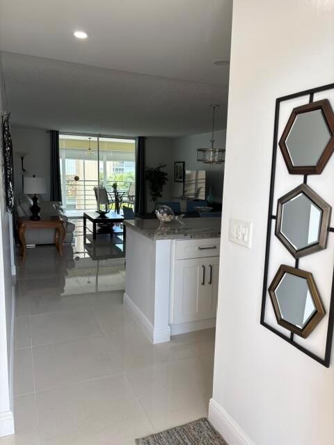 A view from a hallway into an open-concept living area with tile flooring — 424 SE 10th Street # 203, Dania Beach FL 33004, DANIA BEACH, FL