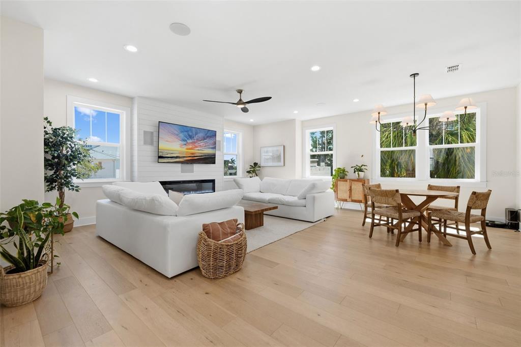 A three-story white house with a gray base, dark trim, and a front-facing garage — 1811 BAYOU GRANDE BOULEVARD NE, ST PETERSBURG, FL