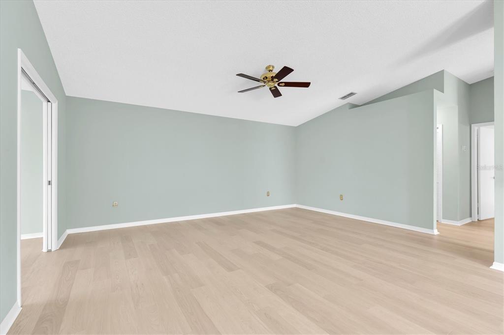 An empty room with light green walls, wood-look flooring, and a ceiling fan — 2023 NASH DRIVE, CLEARWATER, FL