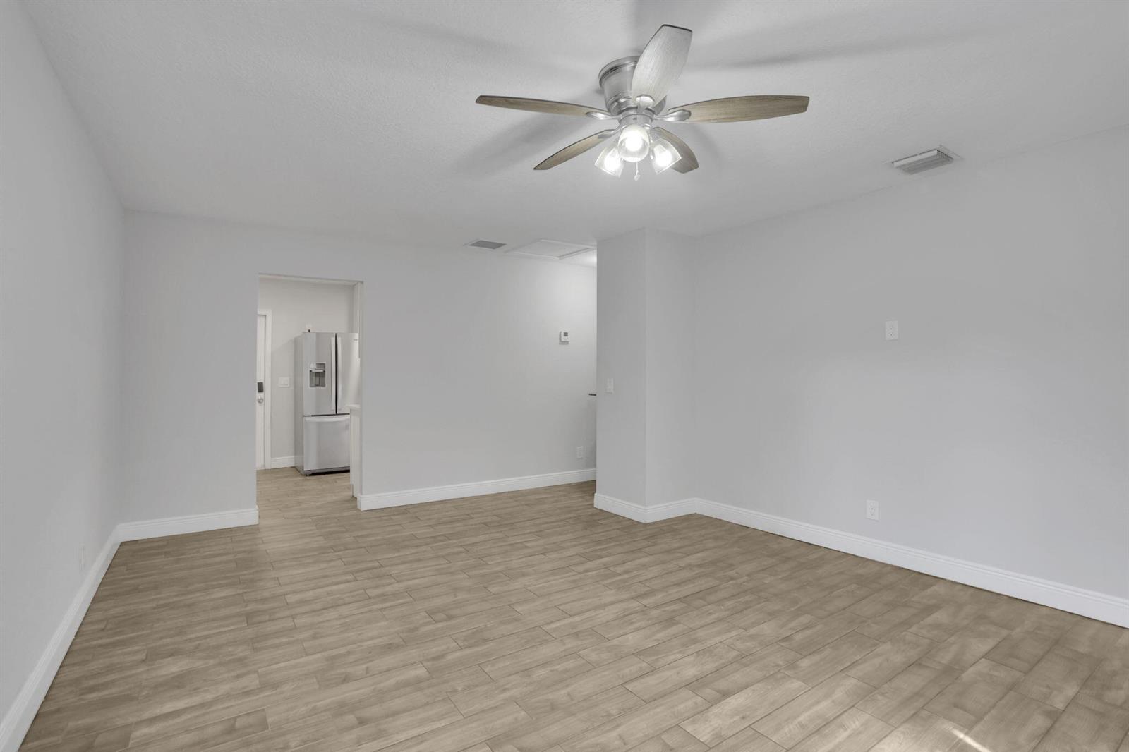 An empty room with light gray walls, wood-look tile flooring, and a ceiling fan — 2227 NE 3rd Avenue # 2, Delray Beach FL 33444, DELRAY BEACH, FL