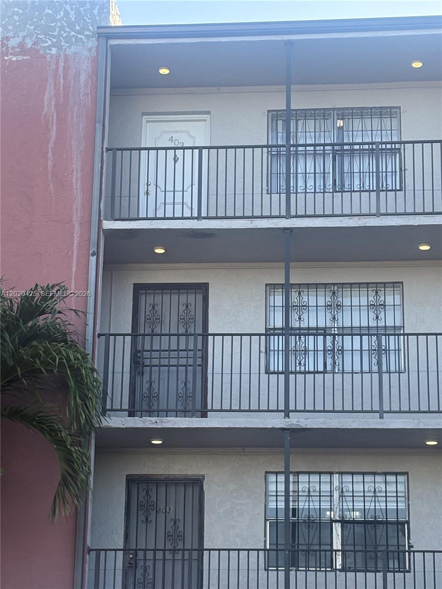 Three stacked apartment balconies with metal railings and security bars on the windows and doors — 6620 W 2nd Ct # 403, Hialeah FL 33012, HIALEAH, FL
