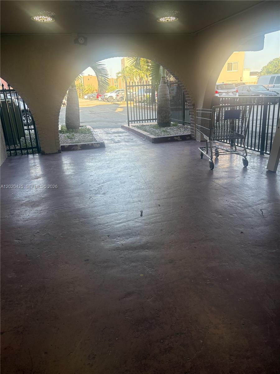 A covered outdoor area features arched openings, a concrete floor, and a metal shopping cart — 6620 W 2nd Ct # 403, Hialeah FL 33012, HIALEAH, FL