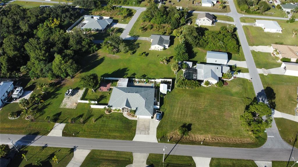 An aerial view shows a residential house with a gray roof and a large yard — 2297 HARBOUR DRIVE, PUNTA GORDA, FL