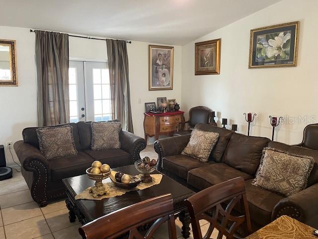 A living room features dark brown leather sofas, a wooden coffee table, and framed wall art — 3723 IMPERIAL DRIVE, WINTER HAVEN, FL