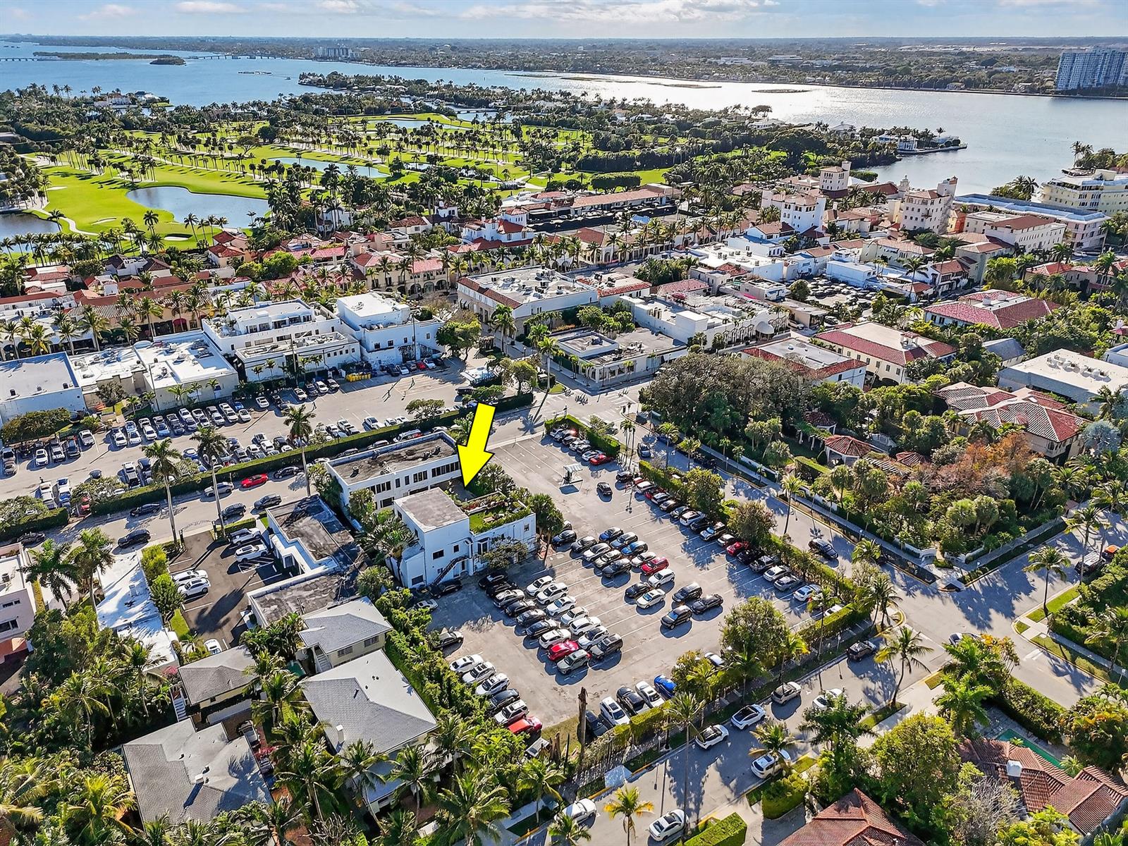 An aerial view shows a multi-story building with a yellow arrow pointing toward it — 249 Peruvian Avenue # 1811, Palm Beach FL 33480, PALM BEACH, FL