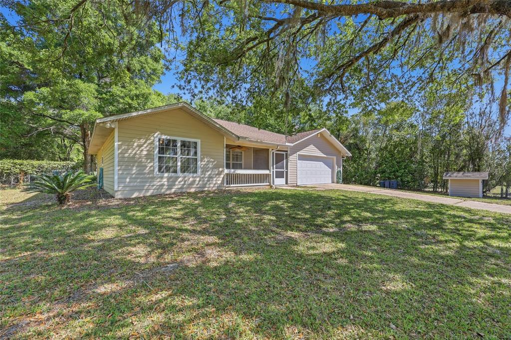 A single-story house with beige siding, a front porch, and a two-car garage — 347 ASHLEY STREET, HAWTHORNE, FL