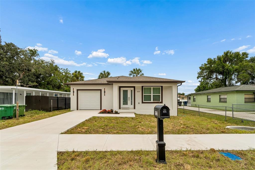 A single-story house with a white exterior, a garage, and a front yard — 4509 N 39TH STREET, TAMPA, FL