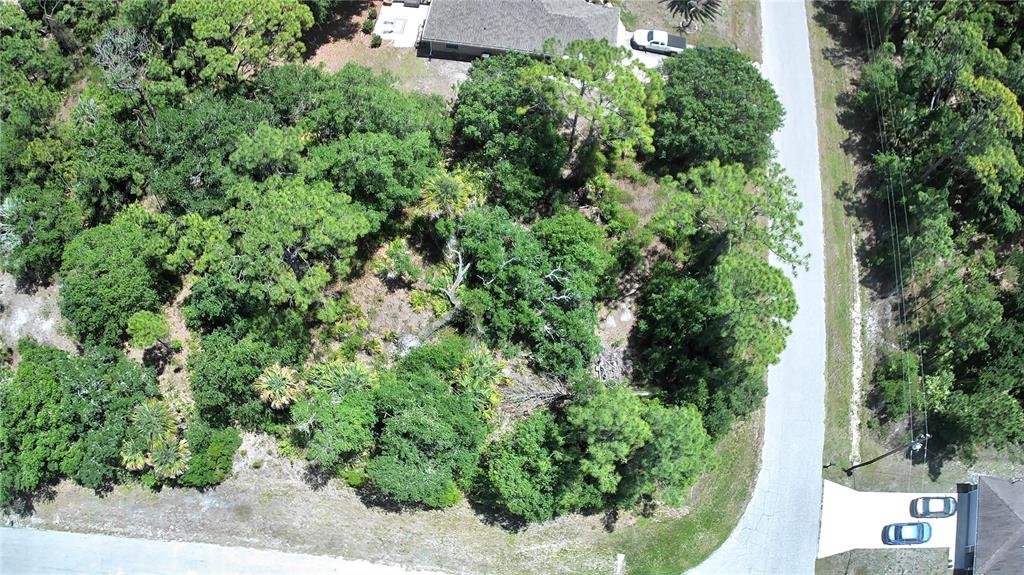 An aerial view shows a wooded residential lot situated between two paved roads — Lot #3 TOWHLEN ROAD, NORTH PORT, FL