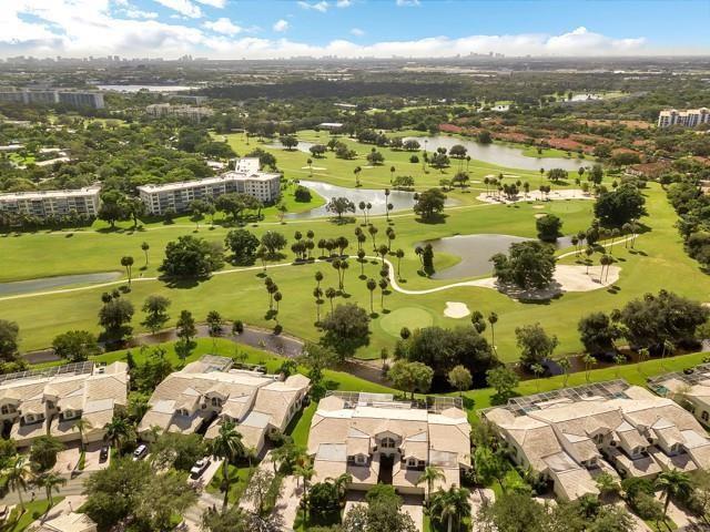 An aerial view shows townhomes overlooking a golf course with ponds and scattered palm trees — 676 W Palm Aire Drive, Pompano Beach FL 33069, POMPANO BEACH, FL