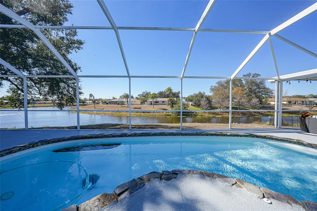 A two-story house with a gray exterior, metal roof, and a concrete driveway — 4053 PINSTAR TERRACE, NORTH PORT, FL