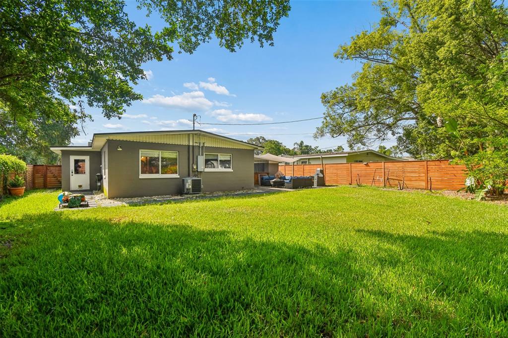 A gray single-story house with a large backyard and a wooden fence — 259 ORANGE TERRACE DRIVE, WINTER PARK, FL