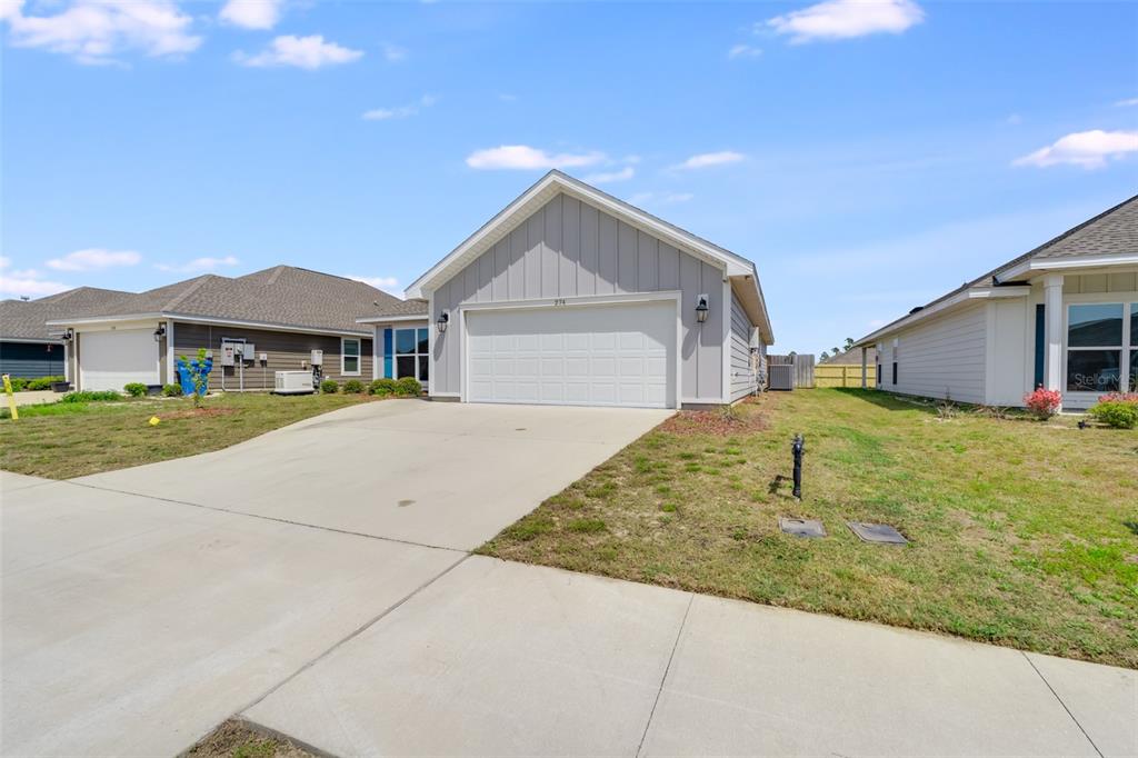 A gray, single-story house with a two-car garage and a concrete driveway — 274 BAYOU BEND LANE, PANAMA CITY, FL