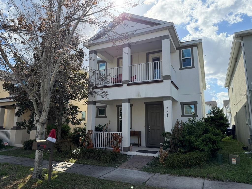 A two-story house with a front porch, a second-floor balcony, and a Santa hat on the mailbox — 8272 BRYCE CANYON AVENUE, WINDERMERE, FL