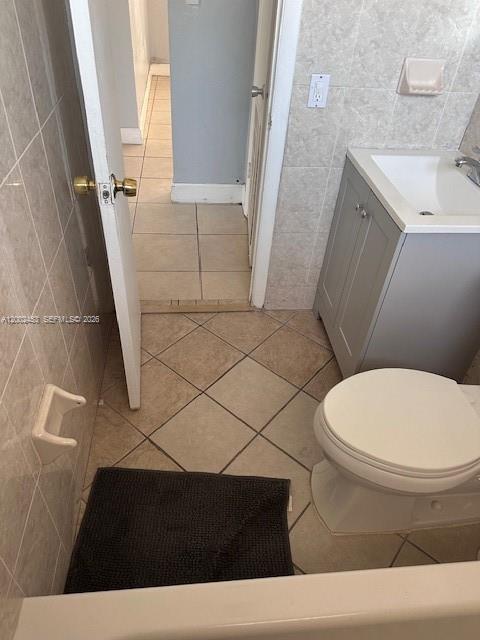 A bathroom features a vanity, toilet, tiled floor, and an open doorway leading to another room — 3723 NW 23rd Ave # 2, Miami FL 33142, MIAMI, FL