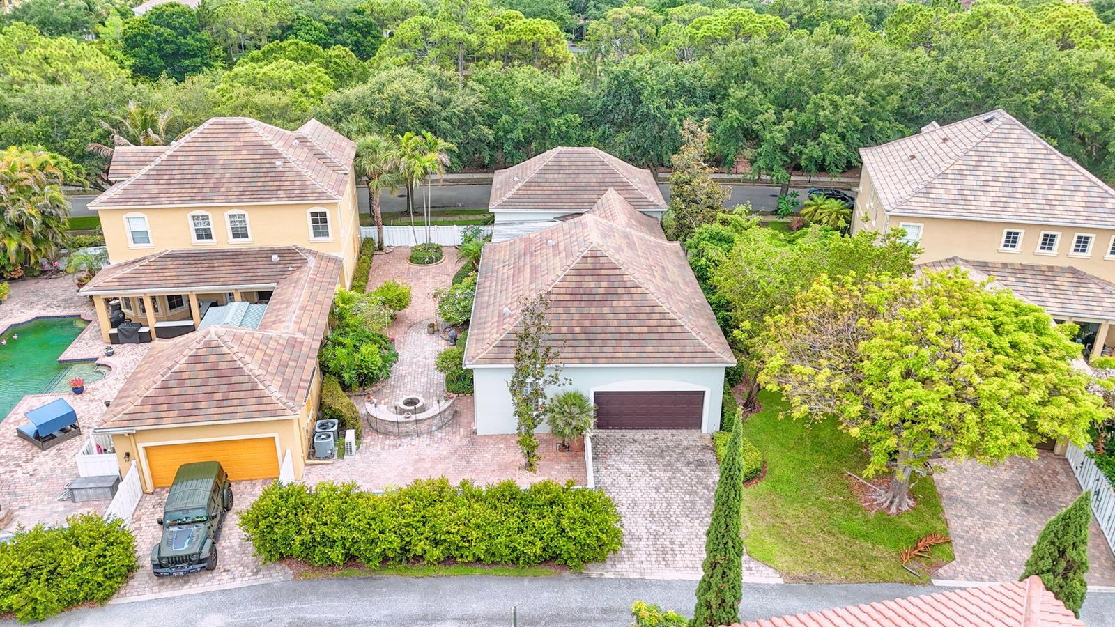 An aerial view shows two multi-story houses with tiled roofs, a pool, and paved courtyards — 127 Arklow Avenue, Jupiter FL 33458, JUPITER, FL