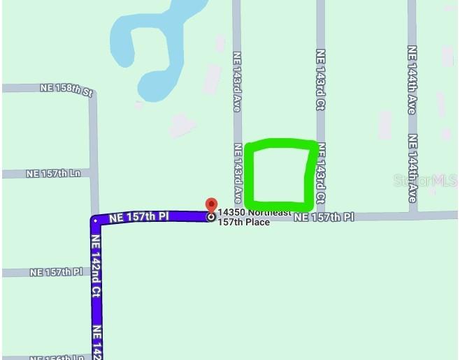 This is a map showing a highlighted rectangular plot of land near a residential street — 0 NE 157 PLACE, FORT MC COY, FL