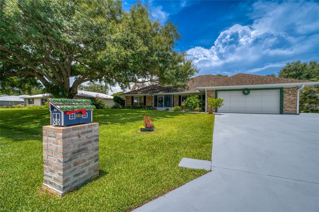 A single-story brick house with a two-car garage and a decorative mailbox in front — 465 11TH AVENUE, VERO BEACH, FL