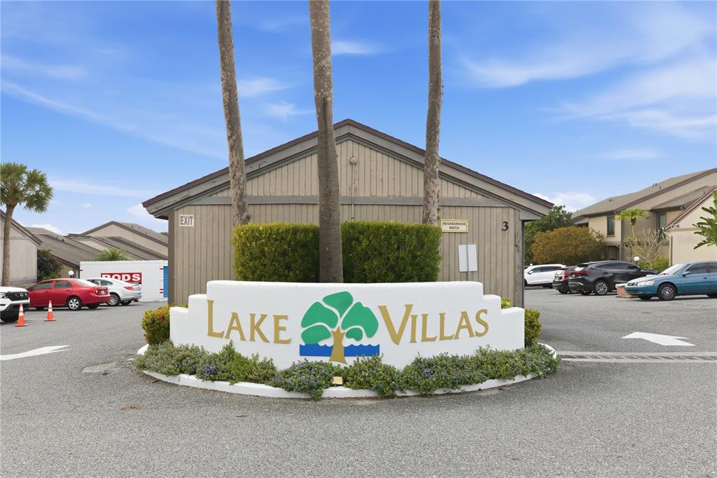A white sign with the text Lake Villas sits in front of a residential building — 654 LAKE VILLAS DRIVE UNIT 654, ALTAMONTE SPRINGS, FL