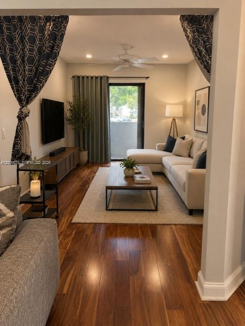 A living room features hardwood floors, a sectional sofa, a coffee table, and a television — 3380 Lucerne Park Dr # 4B, Green Acres FL 33467, GREEN ACRES, FL