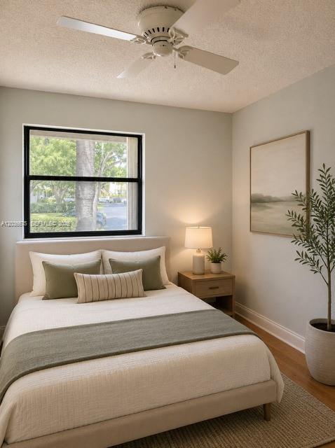 A bedroom features a queen bed, a ceiling fan, a window, and a bedside table — 3380 Lucerne Park Dr # 4B, Green Acres FL 33467, GREEN ACRES, FL