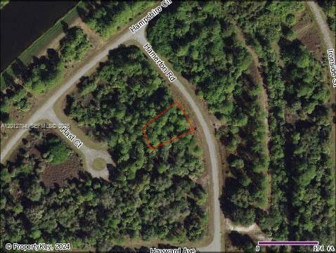 This aerial map shows a vacant, wooded residential lot outlined in red near a curved road — 0 Hamerton, North Port FL 34288, NORTH PORT, FL