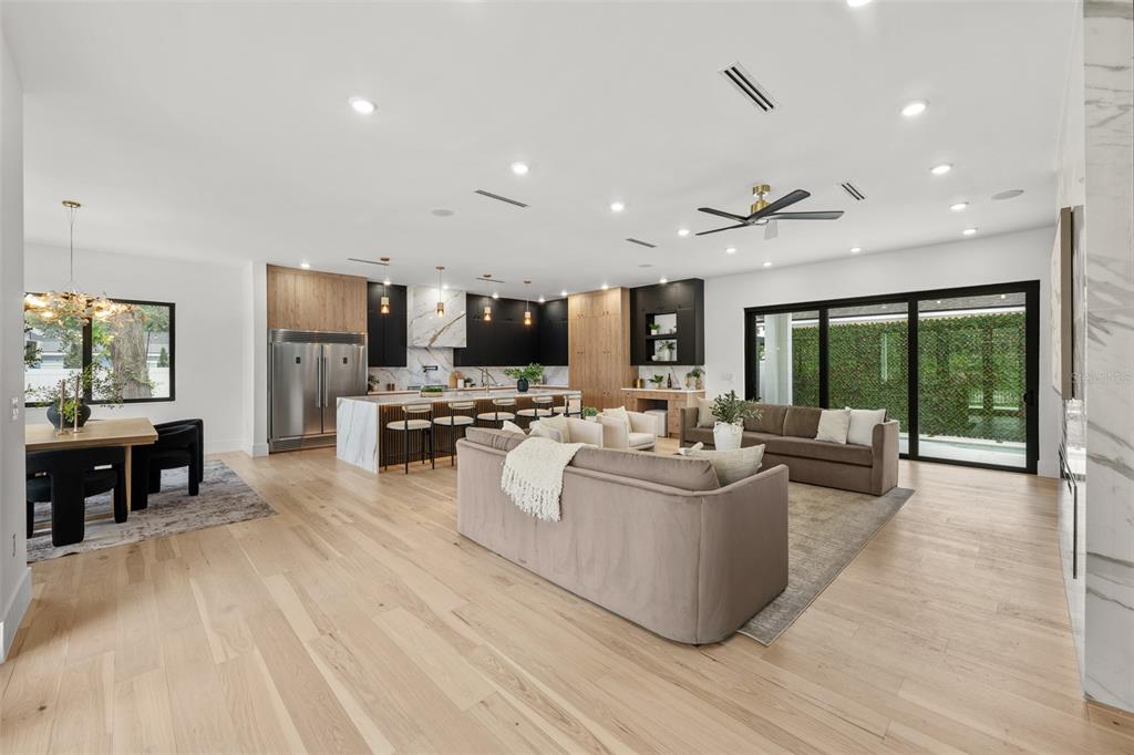 A modern two-story white house with a black metal roof and a second-floor balcony — 12870 N ARMENIA AVENUE, TAMPA, FL