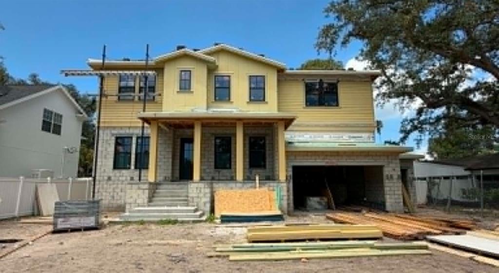 A two-story house under construction with a concrete base, yellow siding, and a front porch — 530 SEVERN AVENUE, TAMPA, FL