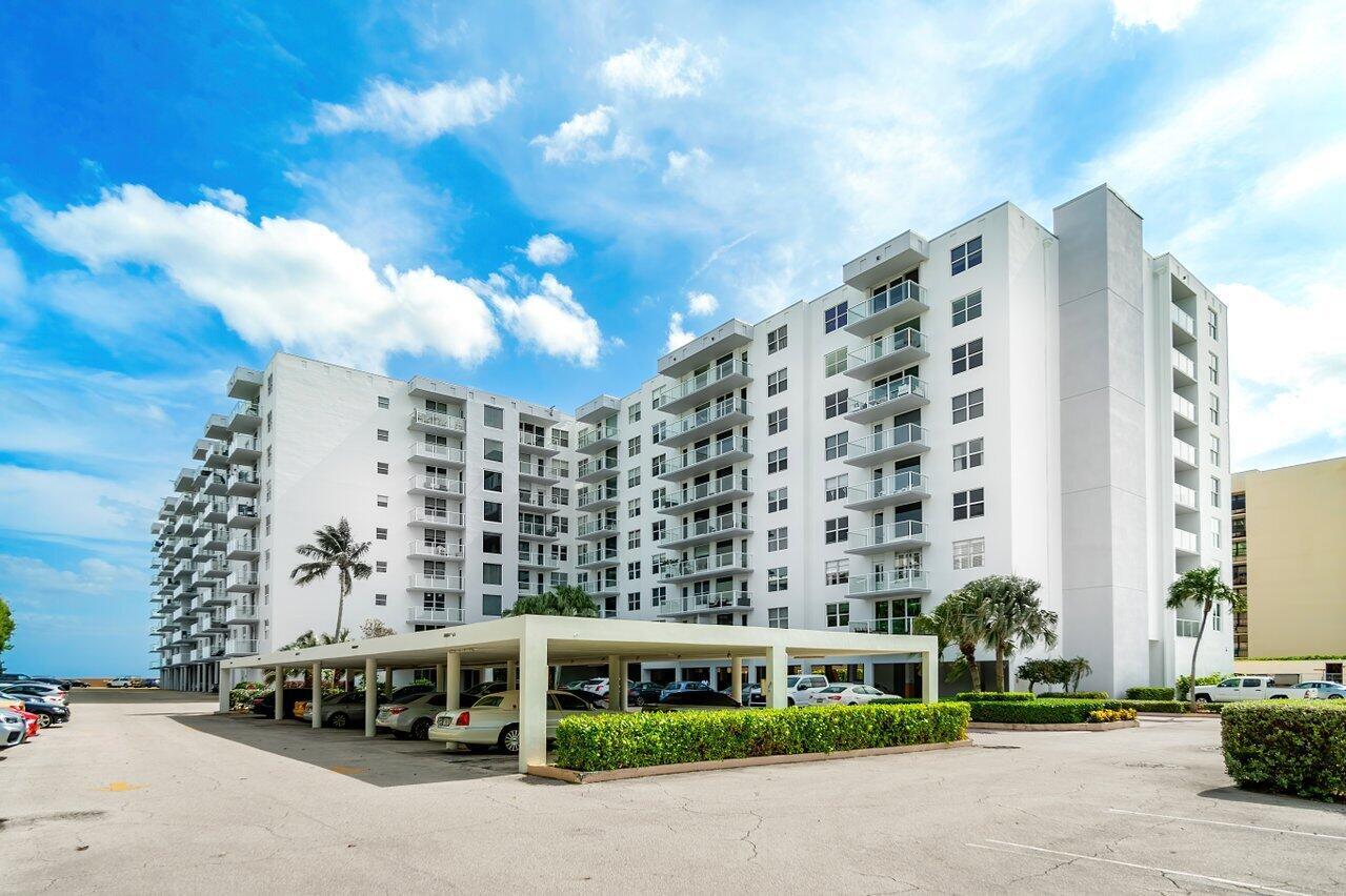 A multi-story white apartment building with balconies and a covered parking structure in front — 3450 S Ocean Boulevard # 5010, Palm Beach FL 33480, PALM BEACH, FL
