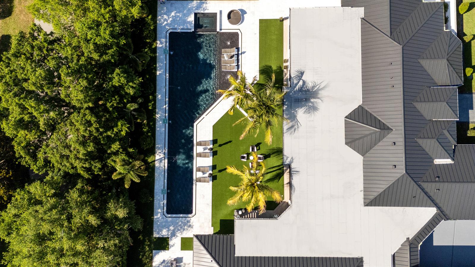 An aerial view shows a rectangular swimming pool, artificial turf lawn, palm trees, and house roof — 17872 W Fieldbrook Circle W, Boca Raton FL 33496, BOCA RATON, FL