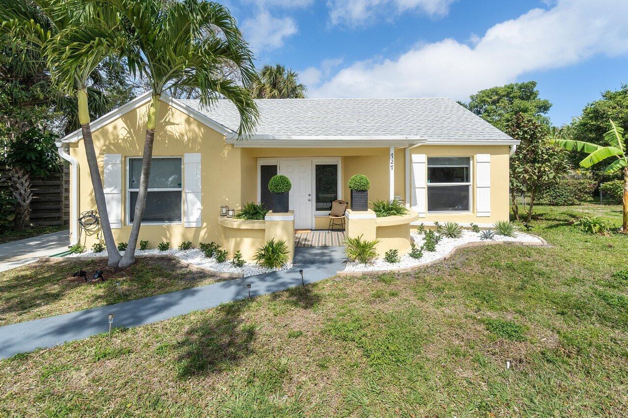 A yellow single-story house with a front porch, white shutters, and a landscaped yard — 727 S Lake Drive, Lantana FL 33462, LANTANA, FL