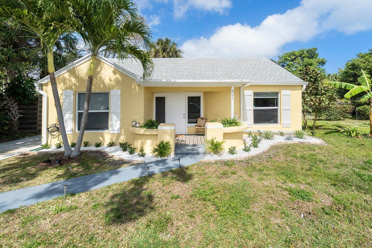 A yellow single-story house with a white roof, front porch, and landscaped yard — 727 S Lake Drive, Lantana FL 33462, LANTANA, FL