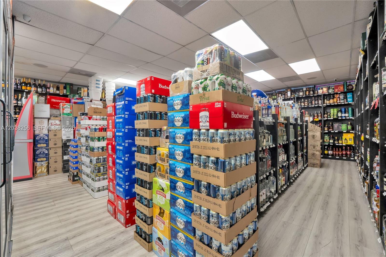 A liquor store interior features aisles stocked with various alcoholic beverages and stacked beer cases — 425 NW 12th ave suite j-k, Miami FL 33128, MIAMI, FL