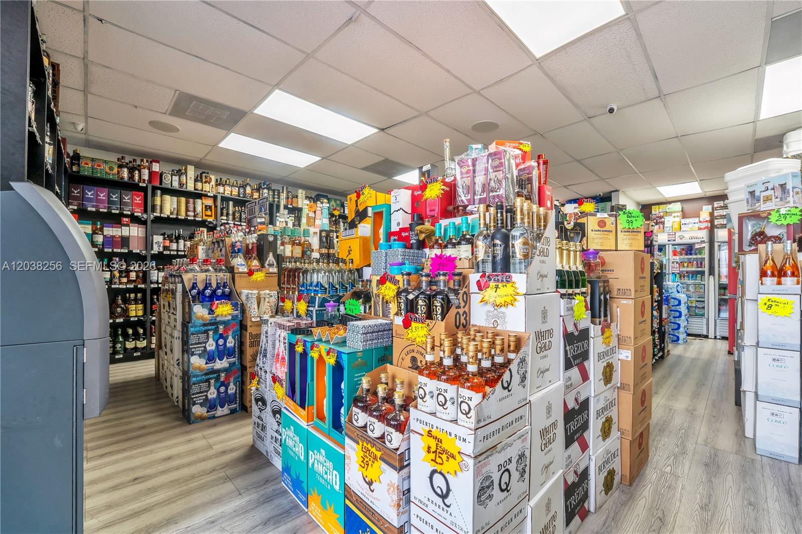 A liquor store interior features shelves stocked with various bottles and stacks of boxed spirits — 425 NW 12th ave suite j-k, Miami FL 33128, MIAMI, FL