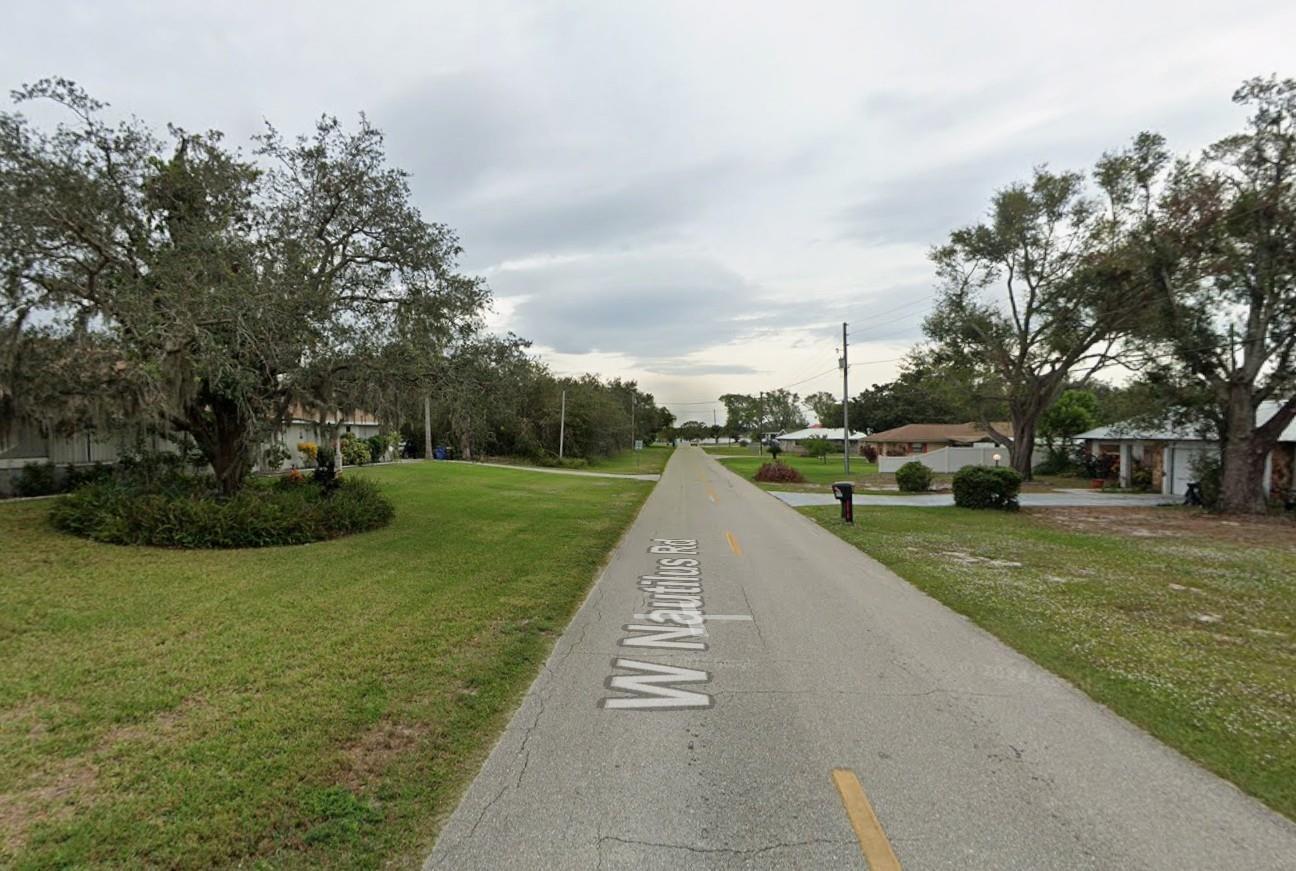 A paved street named W Nautilus Rd runs through a residential neighborhood with grassy lawns — 2479 W Nautilus Road, FL 33825, FL