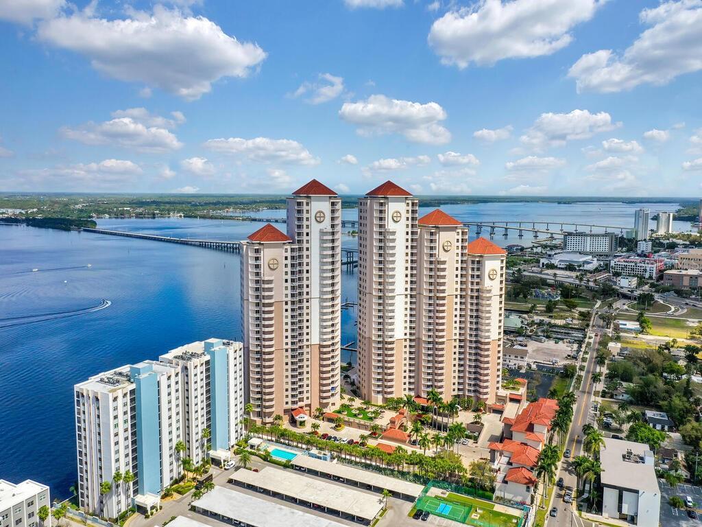 An aerial view of high-rise residential towers situated along a waterfront with a long bridge — 2104 W FIRST STREET UNIT 2304, FORT MYERS, FL