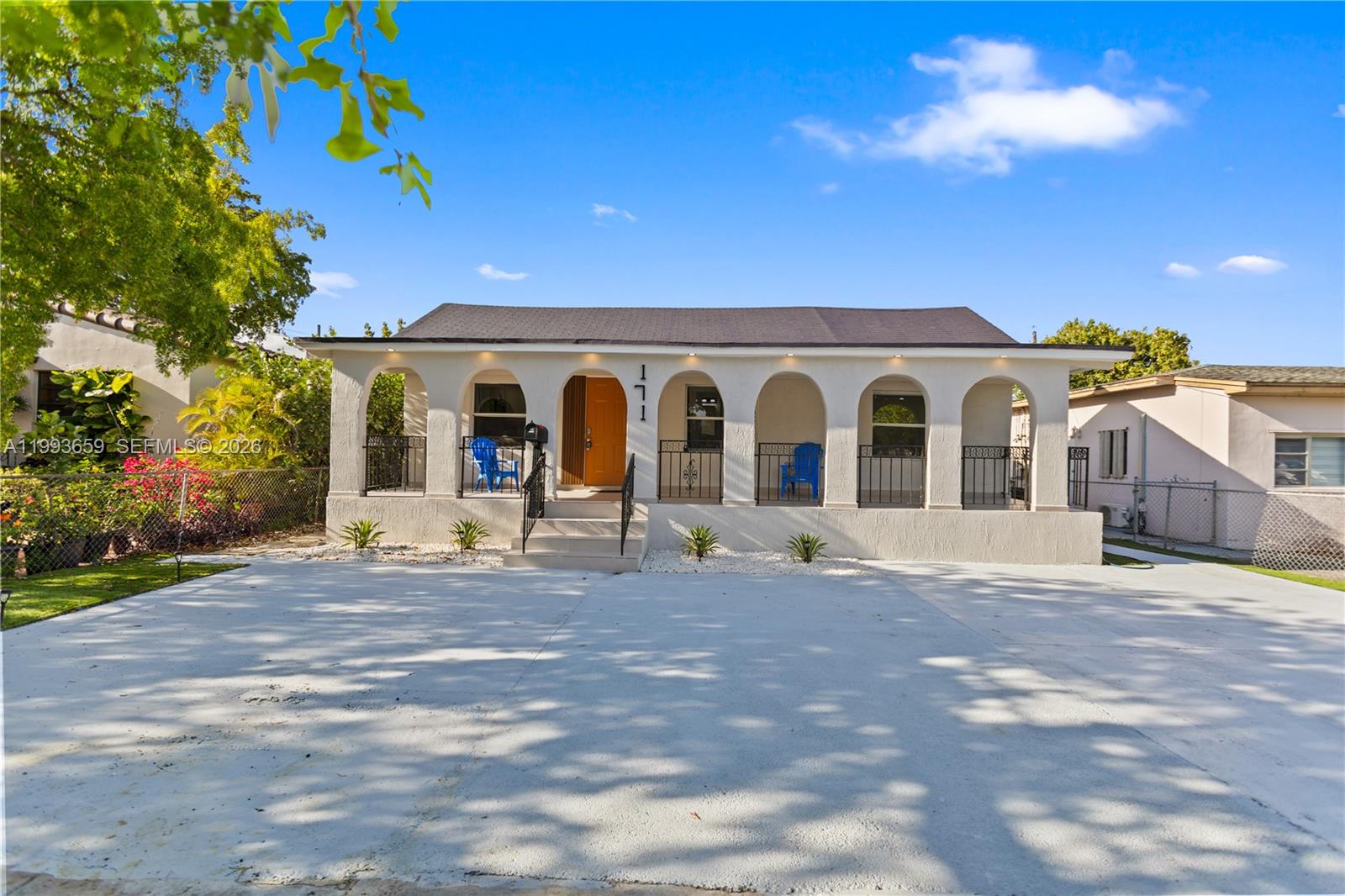 A single-story house features a covered front porch with arched openings and a concrete driveway — 171 W 13th St, Hialeah FL 33010, HIALEAH, FL