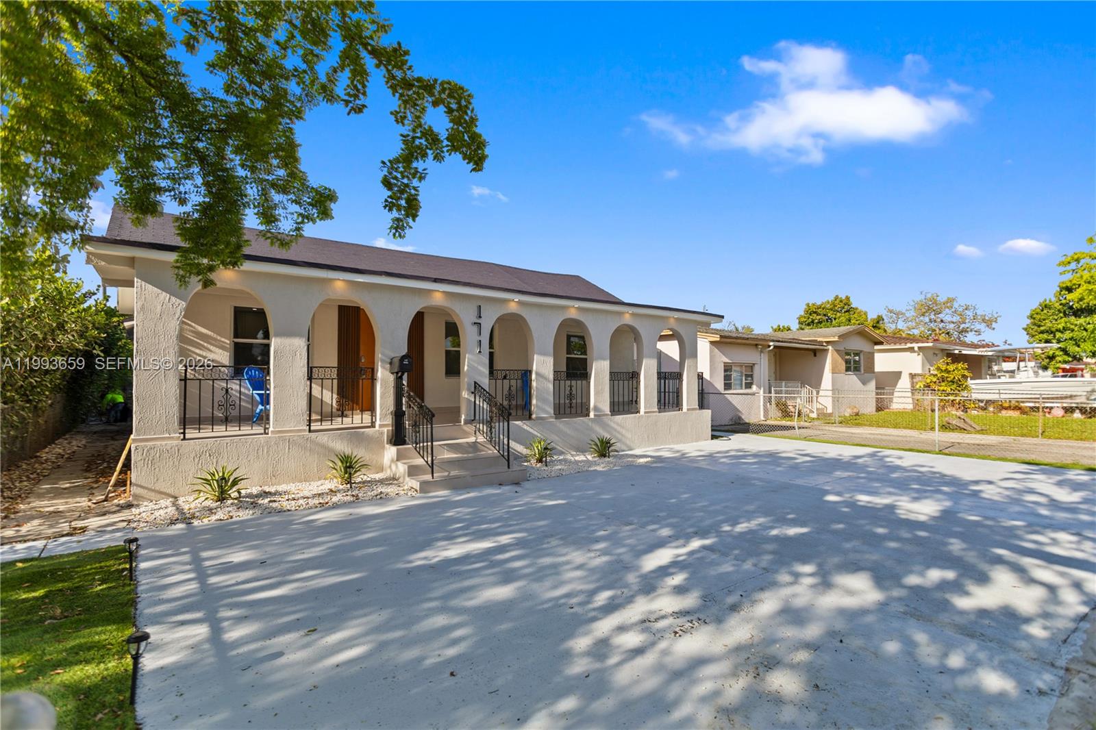 A single-story house features a covered arched porch, a concrete driveway, and a fenced yard — 171 W 13th St, Hialeah FL 33010, HIALEAH, FL