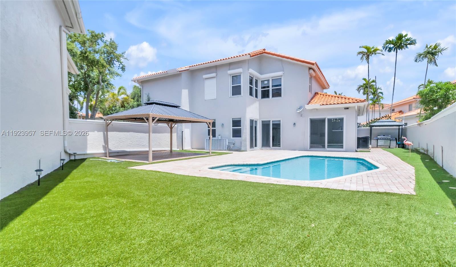 A two-story house with a backyard pool, gazebo, and artificial turf lawn — 1547 Mariner Way, Hollywood FL 33019, HOLLYWOOD, FL
