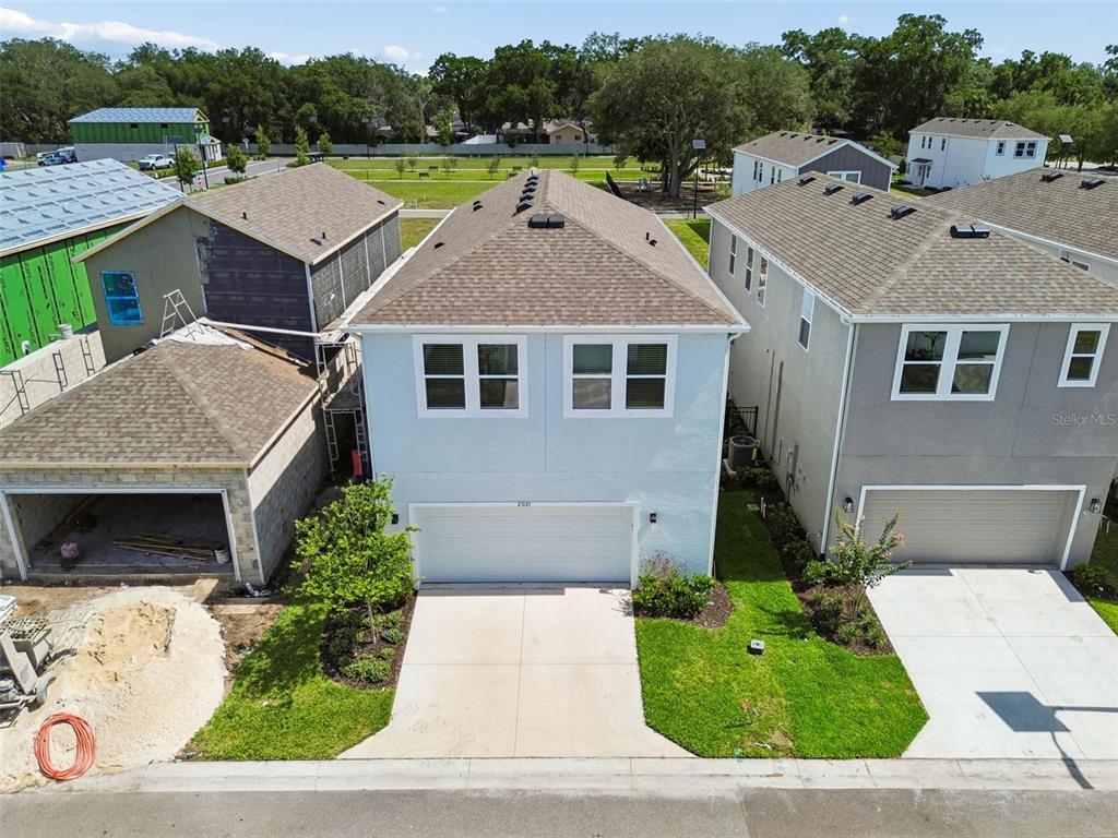 A modern kitchen features white cabinets, quartz countertops, a herringbone backsplash, and stainless steel appliances — 2021 AMELIA BAY PLACE, VALRICO, FL