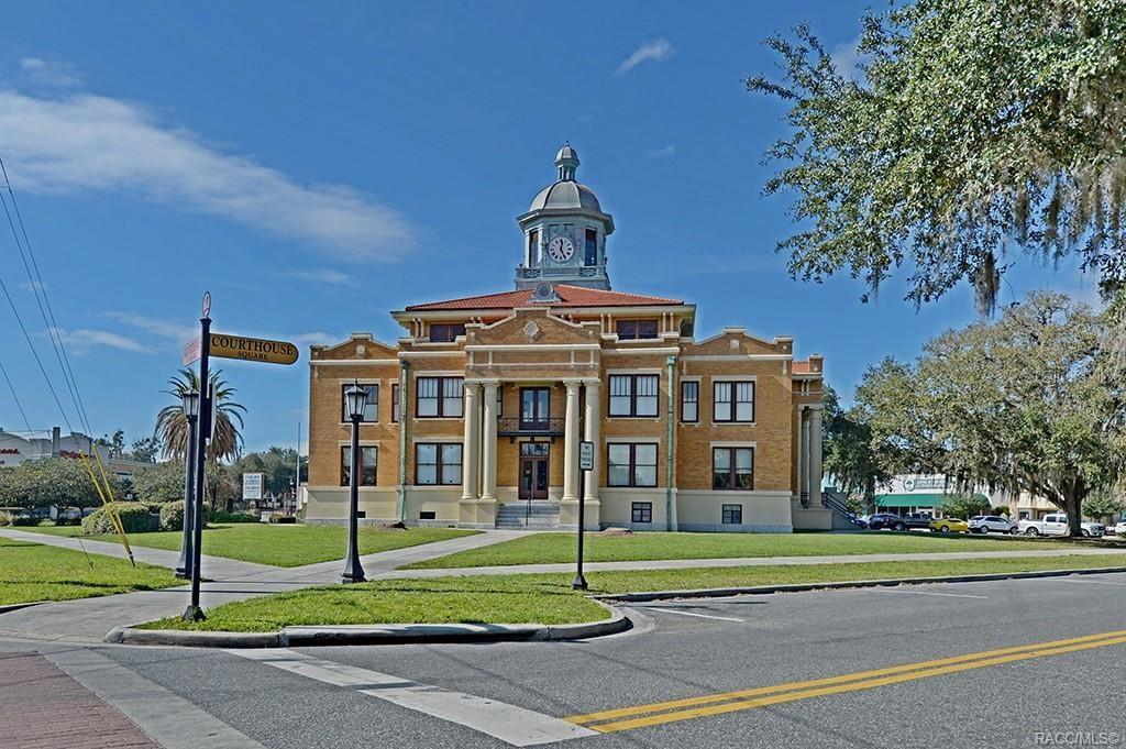A historic yellow brick courthouse building stands on a grassy lot under a blue sky — 2907 CLEARWOOD STREET, INVERNESS, FL