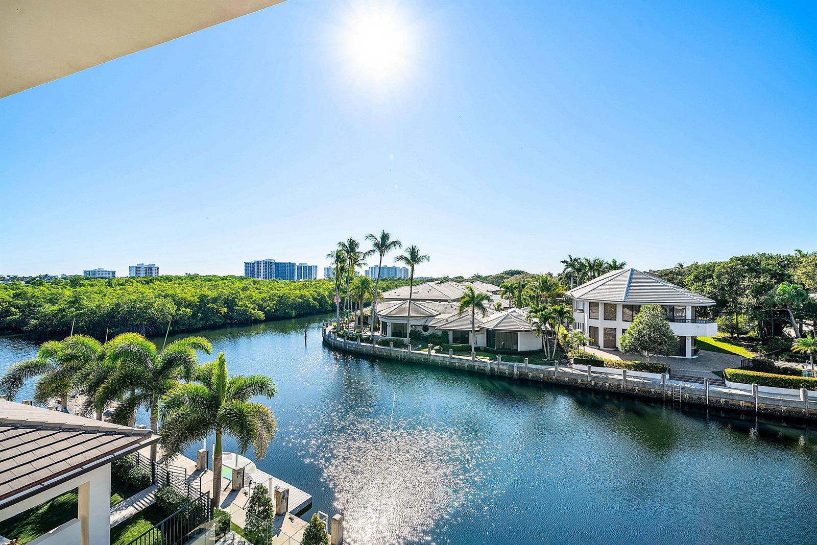 An elevated view of a canal lined with palm trees and luxury waterfront homes — 5344 Boca Marina Circle N, Boca Raton FL 33487, BOCA RATON, FL