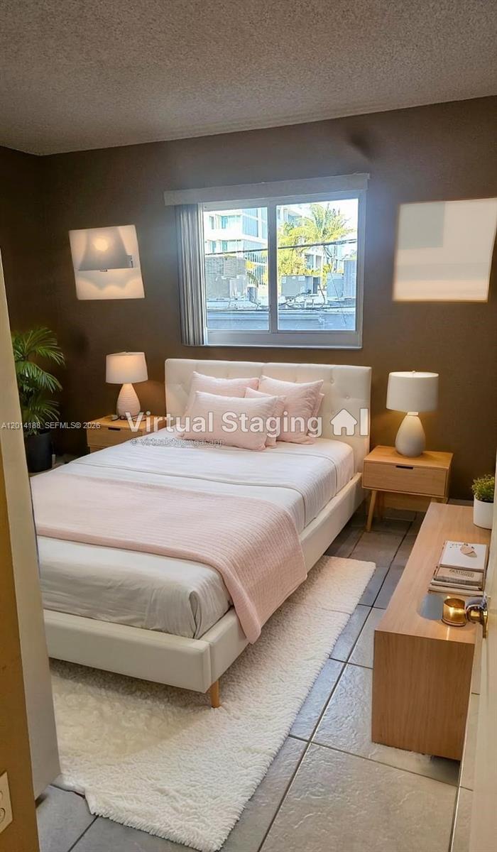 This bedroom features a white bed, two nightstands with lamps, and a window — 6801 Harding Ave # 217, Miami Beach FL 33141, MIAMI BEACH, FL
