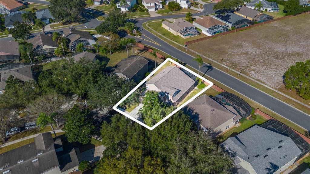 An aerial view shows a residential house with a shingled roof and a driveway — 8019 ACADIA ESTATES COURT, KISSIMMEE, FL
