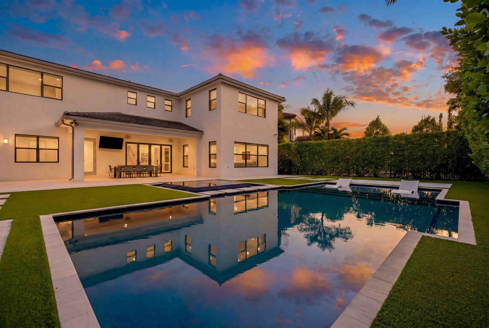A modern two-story house with a swimming pool and patio at sunset — 17558 Cadena Drive, Boca Raton FL 33496, BOCA RATON, FL
