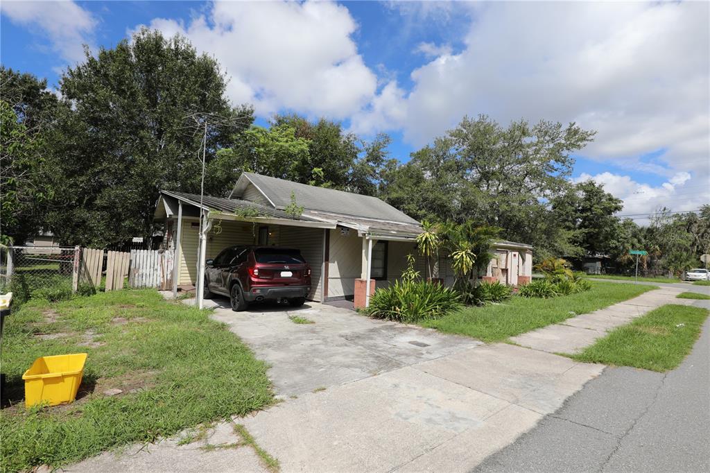 A single-story house with a carport, a parked car, and a grassy front yard — 2747 EATON AVENUE, LAKELAND, FL