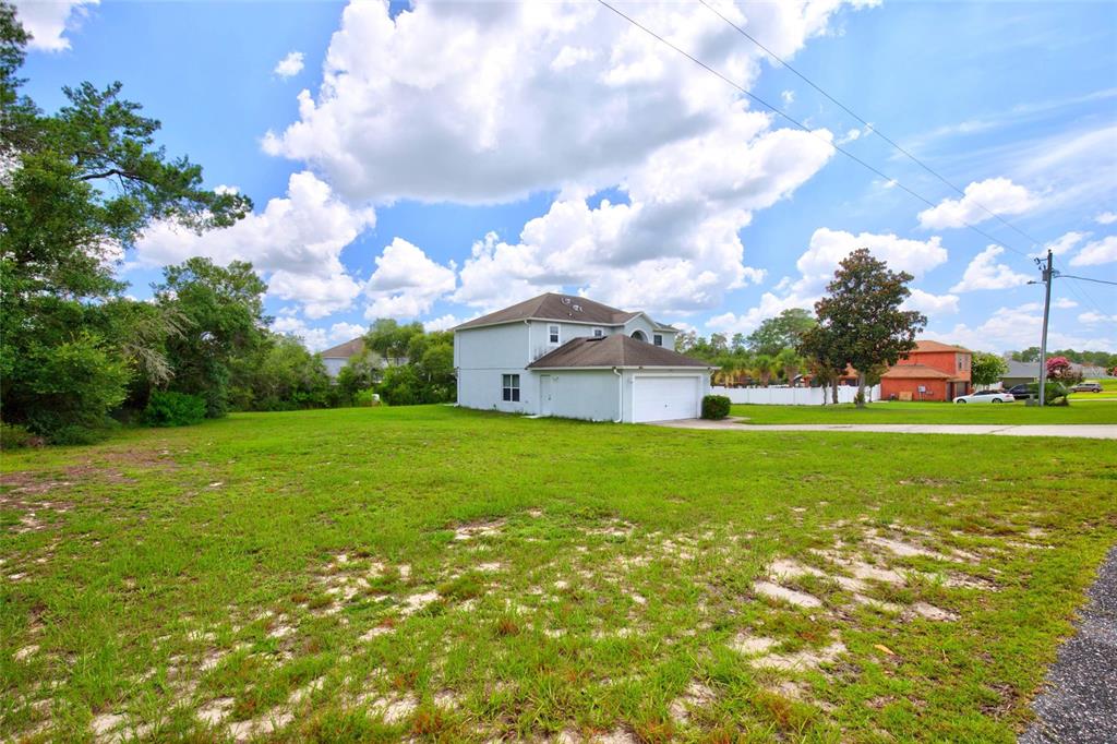 A two-story house with a white garage sits on a large, grassy lot — 3960 SW 110TH LANE, OCALA, FL