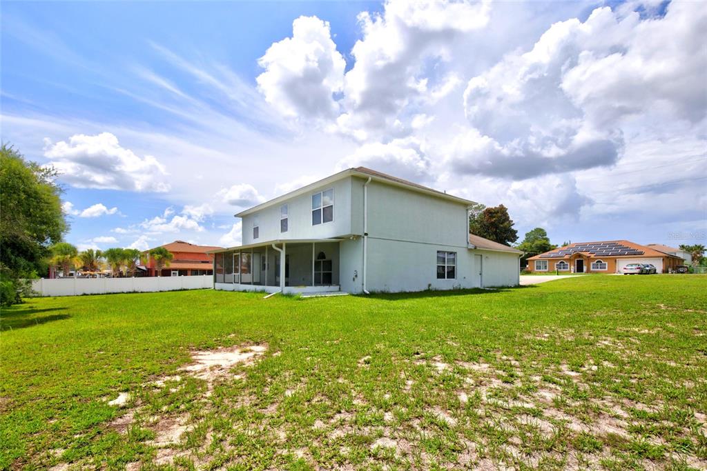 The exterior of a two-story house with a screened-in porch sits on a large lawn — 3960 SW 110TH LANE, OCALA, FL