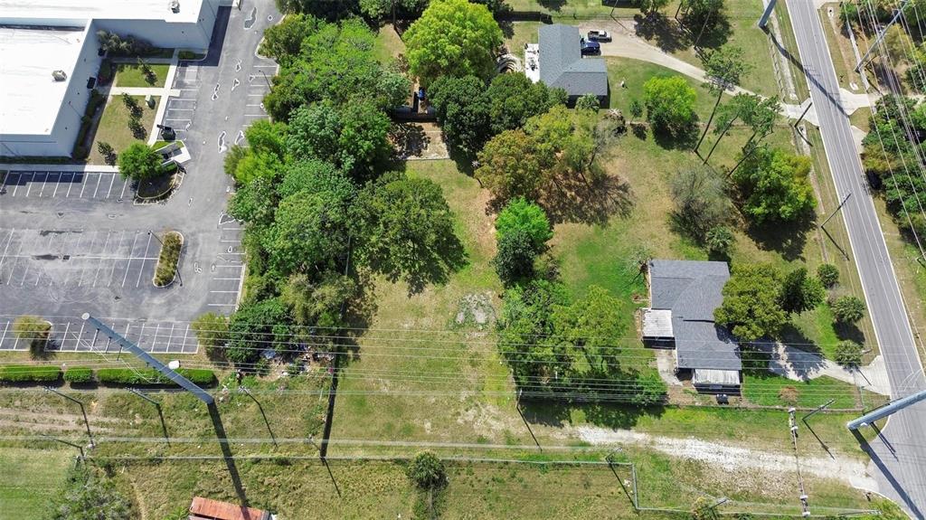 An aerial view shows a rectangular lot with trees, a house, and an adjacent parking lot — 11602 IROQUOIS TRAIL, ORLANDO, FL