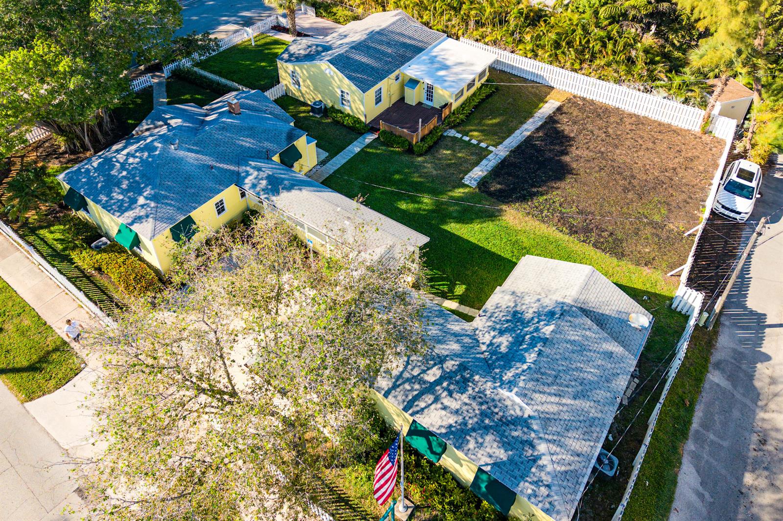 An aerial view shows two yellow houses with grey roofs and a shared backyard — 201 NE 1st Avenue, Delray Beach FL 33444, DELRAY BEACH, FL