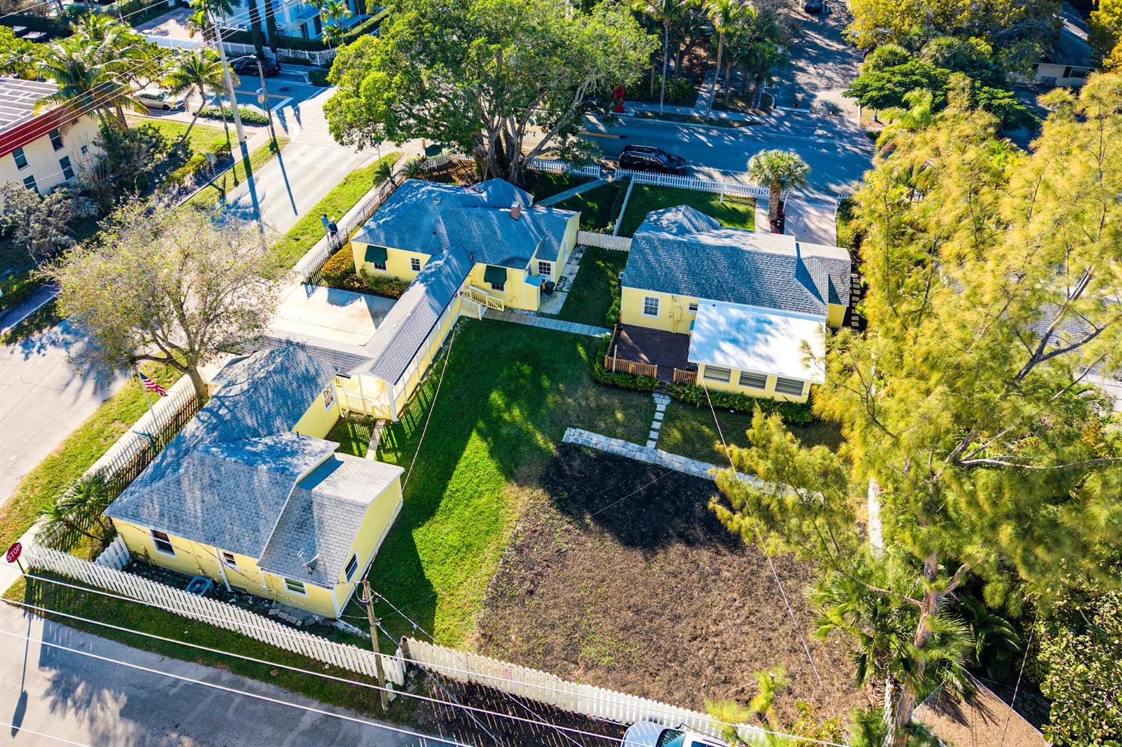 An aerial view shows yellow houses with gray roofs and a fenced yard — 201 NE 1st Avenue, Delray Beach FL 33444, DELRAY BEACH, FL